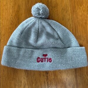 Wonderkids gray beanie with “Cutie” embroidered on front. Pom Pom top.